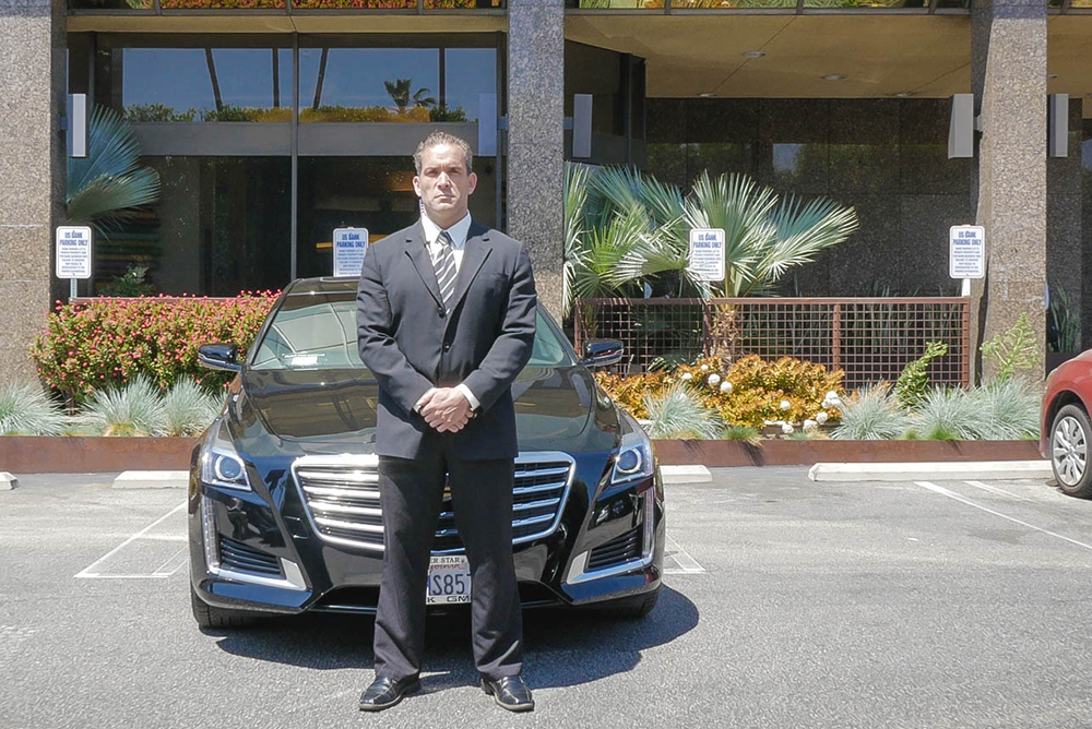 Male bodyguard uses security earpiece outdoors