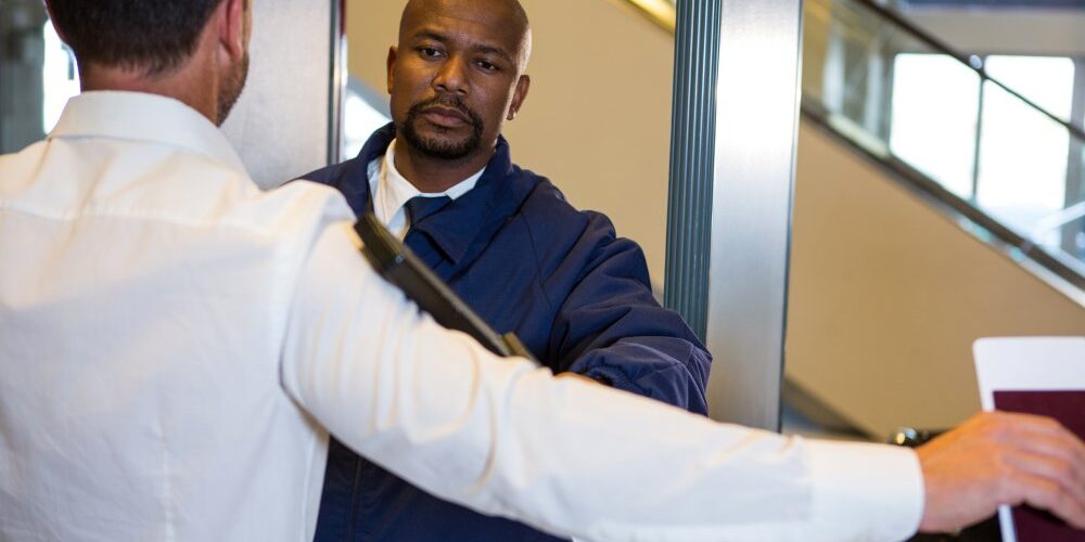 security-guard-frisking-passenger professional security officers LA